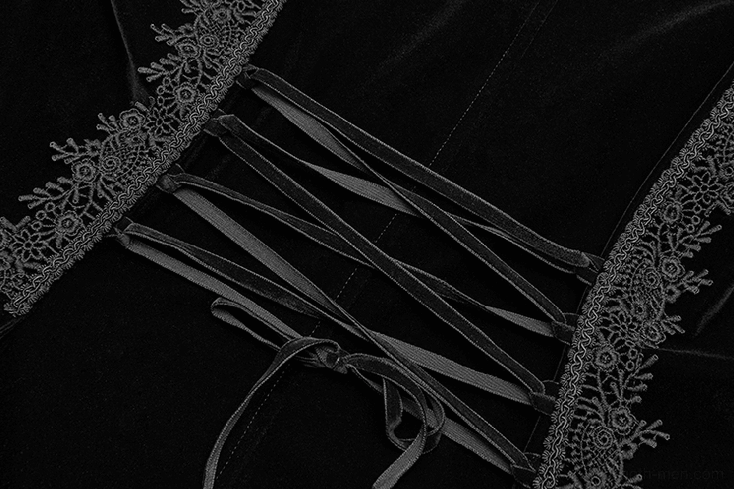Macro close-up showing decorative satin lace-up straps and ornate lace edge trim on gothic cape