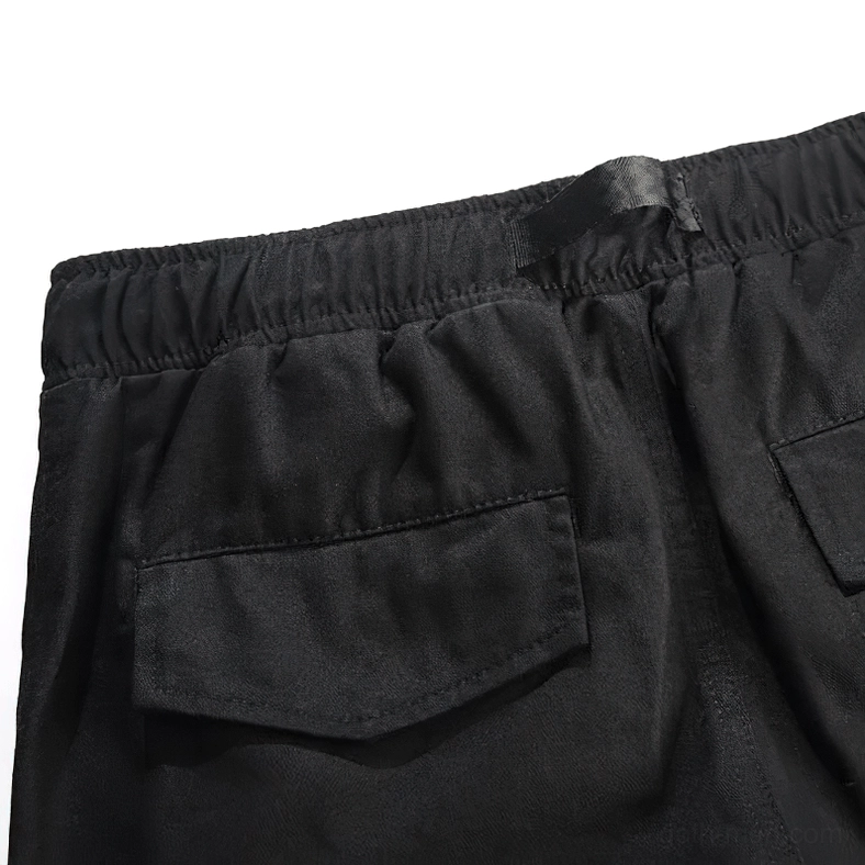 Black cargo pants pocket construction showing utility and functionality