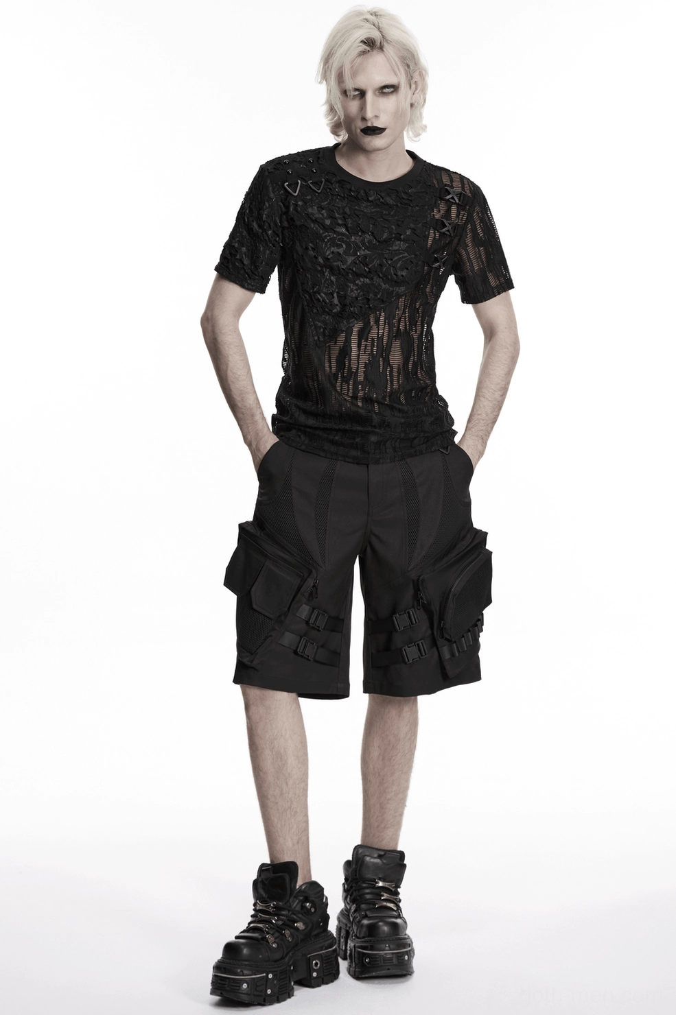 Front three-quarter view of black gothic cargo shorts highlighting buckle strap system and industrial design