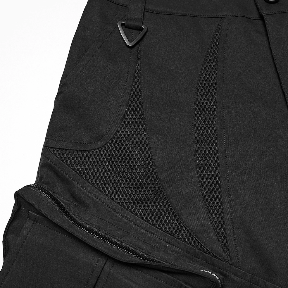 Close-up low-angle shot of black gothic cargo shorts mesh panels, D-ring hardware, and zippered fly construction