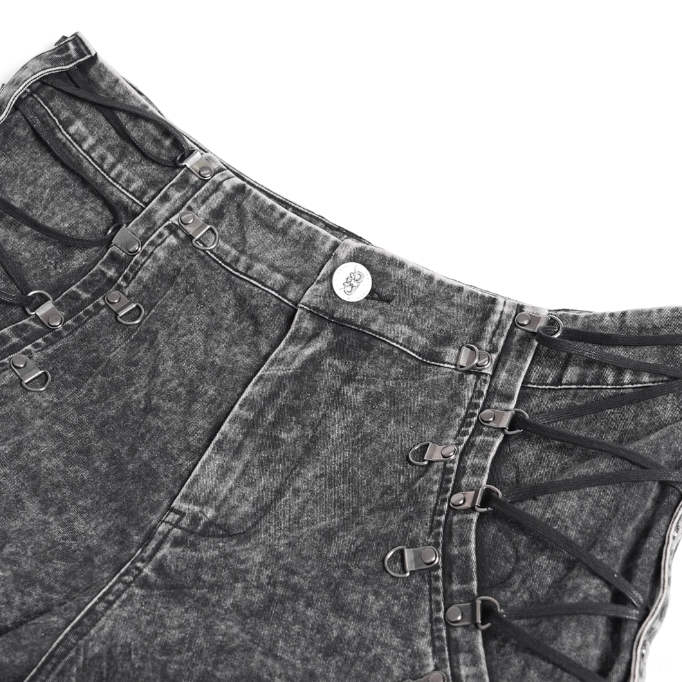 Black gothic chain jeans waist close-up, acid-washed cotton denim with metal buckles and industrial lace-up side closure system detail