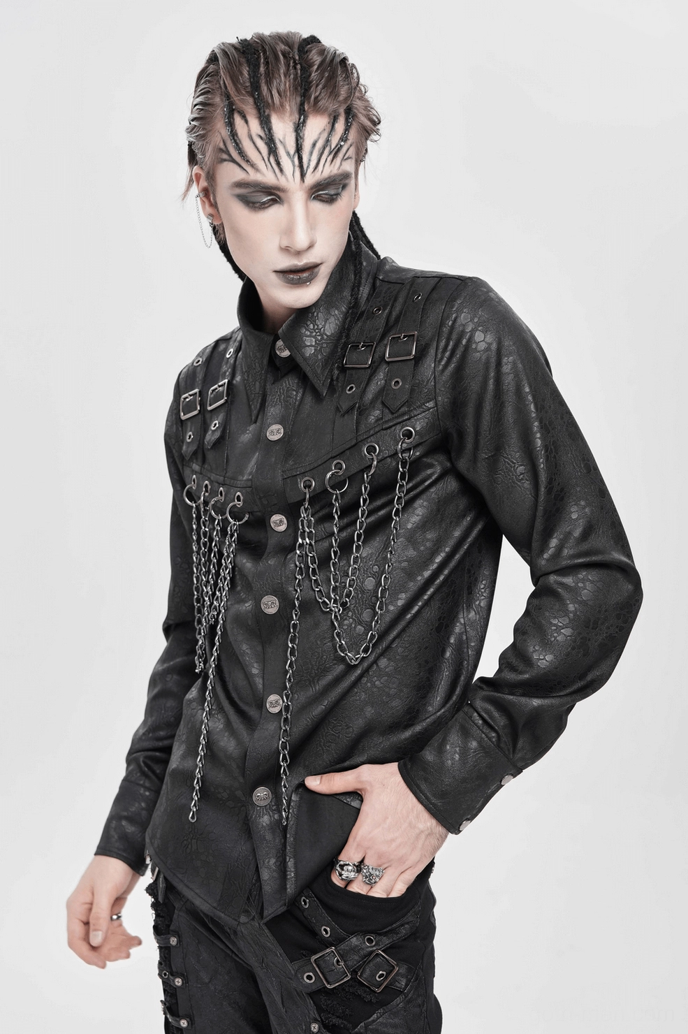 Black gothic chain shirt front pocket and button detail highlighting metal hardware and decorative buckle placement on textured fabric