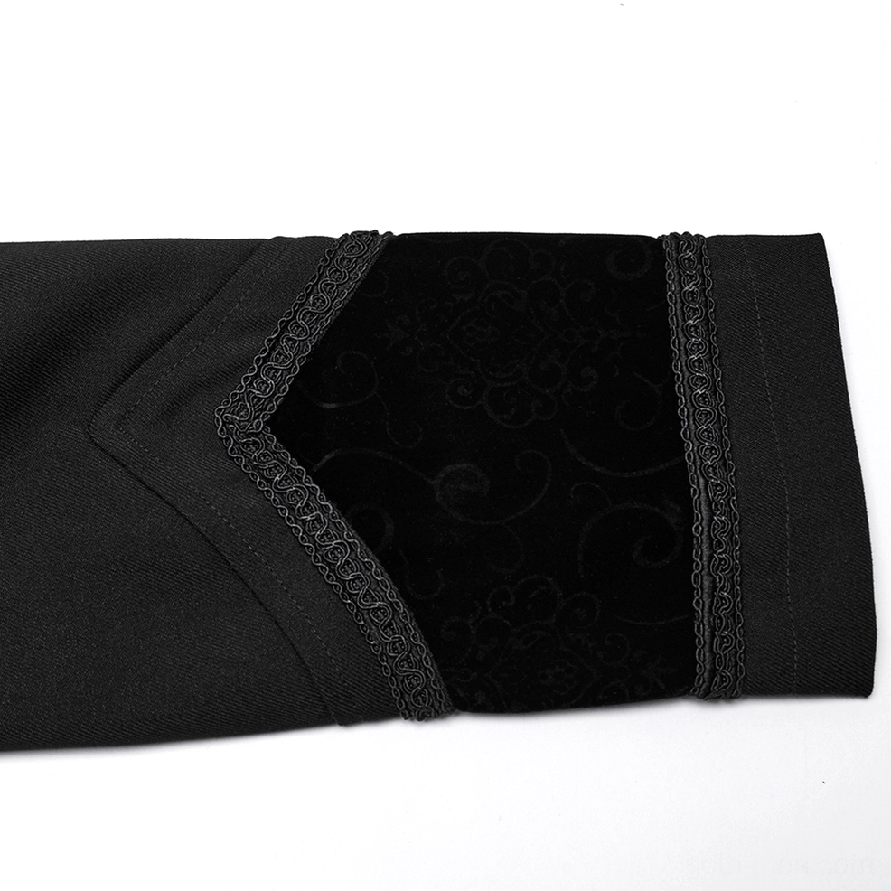 Close-up detail of black gothic cloak cuff and woven fabric accents with braided trim and embroidered velvet panel