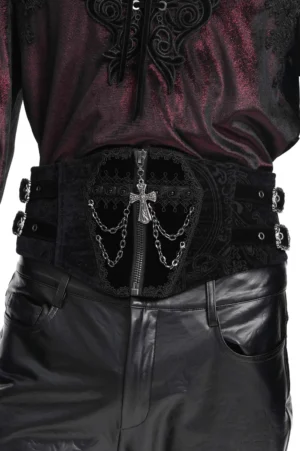 Black gothic corset belt with ornate cross and chain embellishment on front zipper, close-up detail view showing velvet texture and embossed paisley pattern