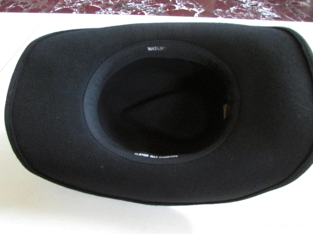 Interior view of black gothic cowboy hat showing woolen material, size label, and crown construction