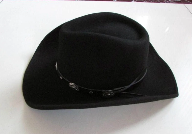 Left side profile of black matte wool gothic cowboy hat showing leather strap with metal charm details