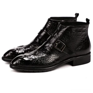 Black crocodile leather gothic chelsea boots with buckle strap and pointed toe, three-quarter view