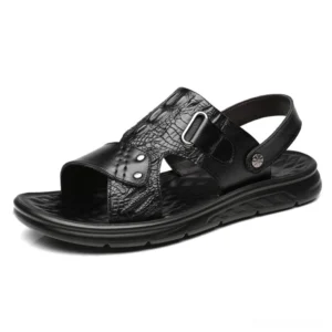 Black crocodile embossed leather sandals with adjustable buckle strap, three-quarter side view showcasing reptilian texture and gothic aesthetic