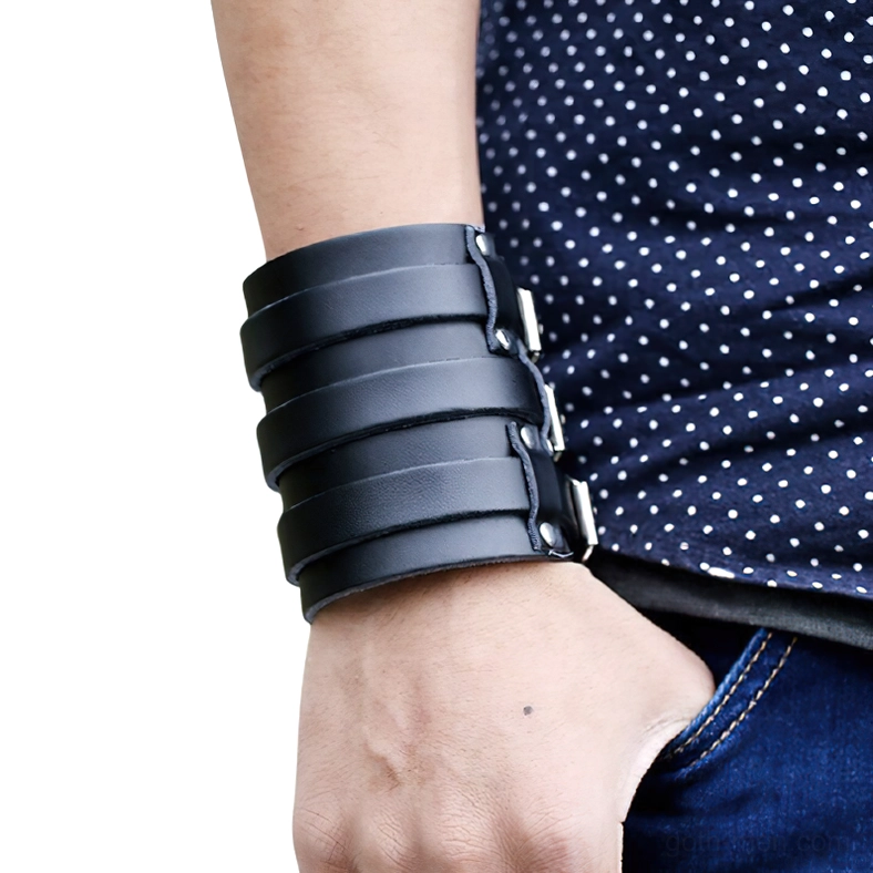 Black leather gothic cuff bracelet being worn on male wrist, showing real-world fit and side-wearing perspective