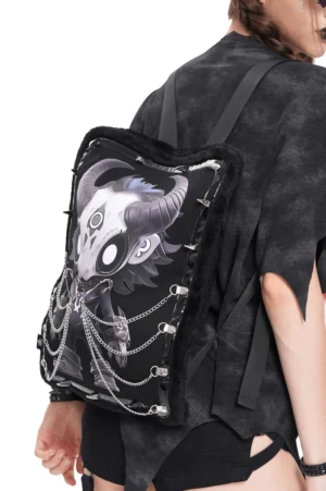 Demon skull gothic backpack with fur trim displayed from side angle, highlighting chain accents and black fuzzy exterior on model