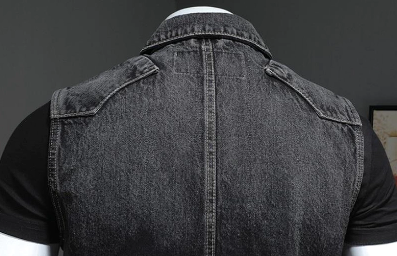 Rear detail view of black denim gothic vest showing full yoke panel and professional seam construction