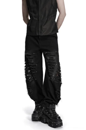 Black gothic distressed denim pants with mesh rips front view studded details male model