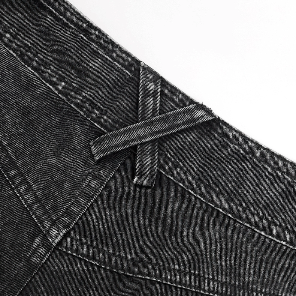 Full-length front view of black gothic distressed flared jeans displaying loose fit and wide-leg silhouette