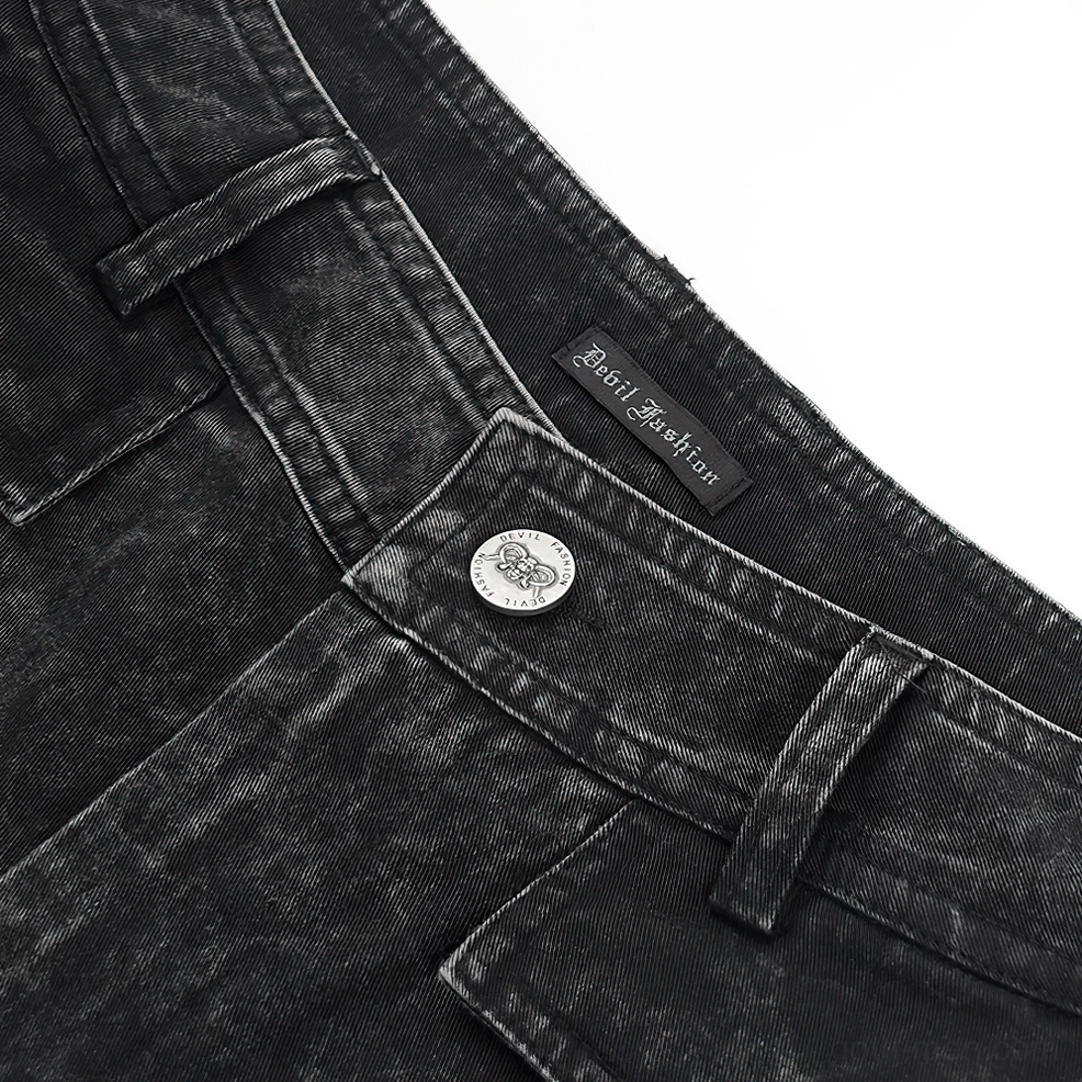 Close-up overhead shot of waistband showing metal button, brand tag, and belt loops on washed black denim