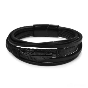Black leather multi-layer gothic bracelet with matte black magnetic clasp and feather charm, top-down flat lay view