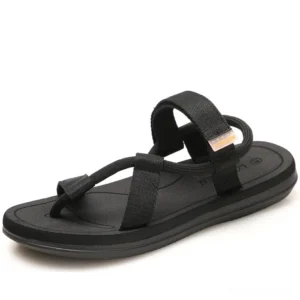 Black gothic gladiator sandals with thong strap and ankle webbing, top three-quarter view on white background