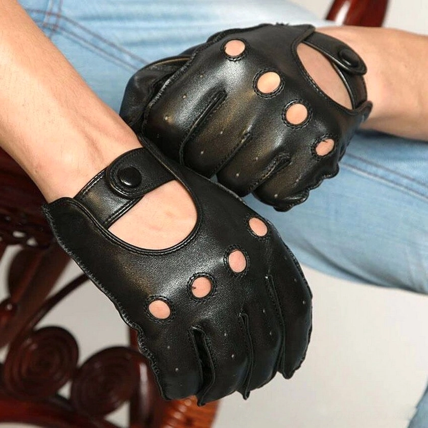 Top-down close-up of black leather gothic gloves worn with blue denim pants, displaying full palm touchscreen capability and breathable design