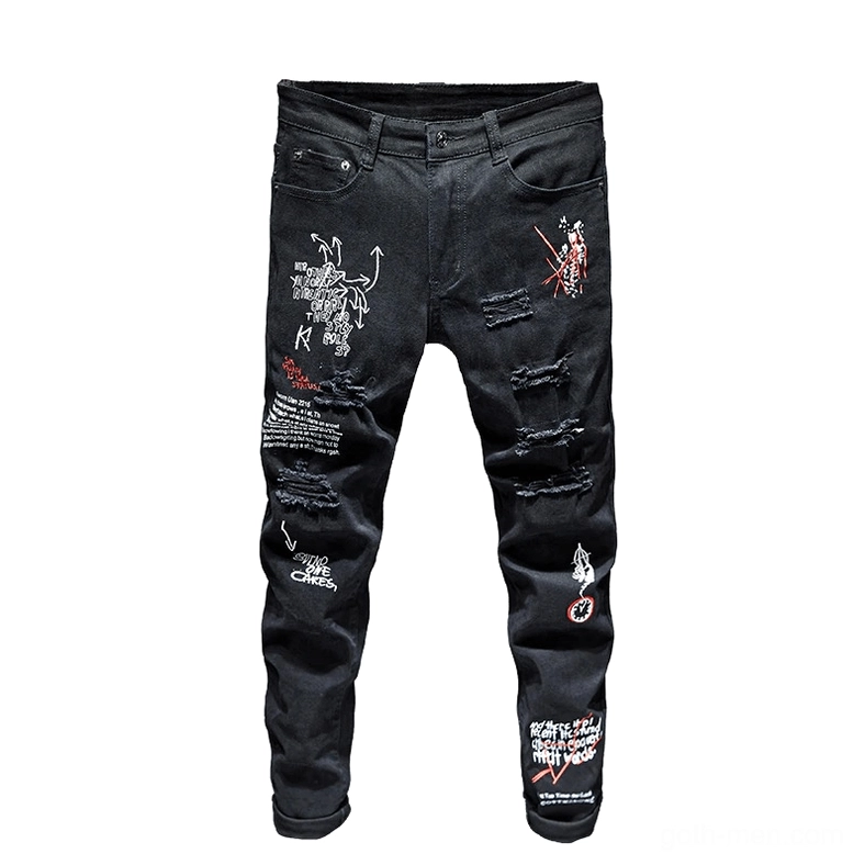 Black gothic ripped jeans flat lay display showing graffiti prints and destroyed cut details