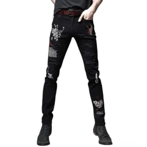 Black gothic graffiti ripped slim jeans with letter prints worn by male model, front three-quarter view