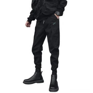 Black gothic harem cargo joggers front three-quarter view with drawstring waist and tapered cuffs on male model