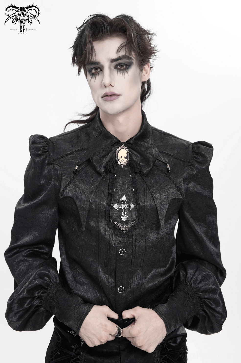 Black gothic jabot choker on model displaying cross pendant, cameo brooch, and overall dramatic silhouette design