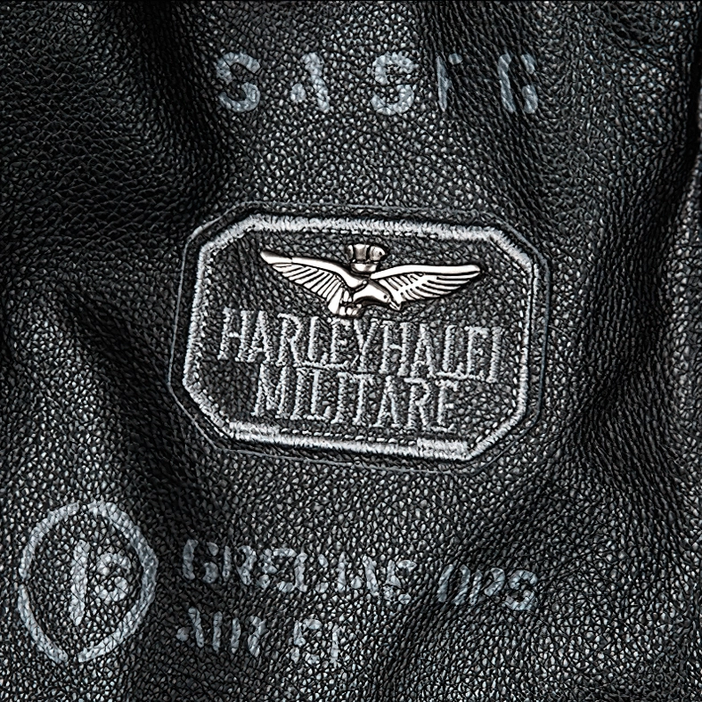 Black leather gothic motorcycle jacket showing embroidered patches and structured turn-down collar detail