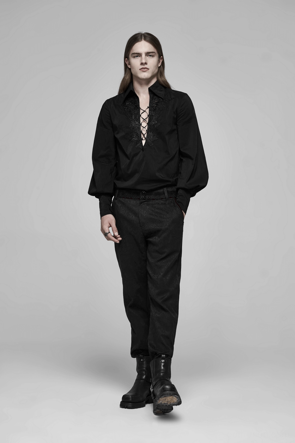 Black gothic jacquard slim-fit pants waistband detail revealing red lace overlay, metal button hardware, and velveteen lining