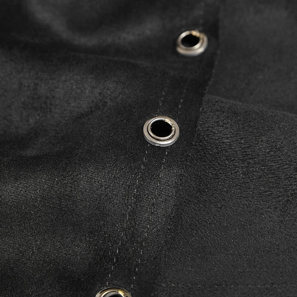 Close-up macro detail of black gothic kilt grommets showing round metal eyelets, stitched fabric seams, and matte suede texture