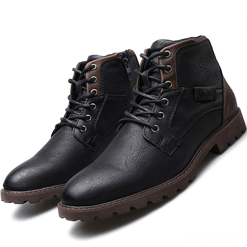 Black leather gothic ankle boots with lace-up closure and rugged rubber sole, studio front view
