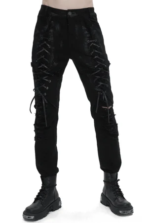 Male model wearing black gothic slim-fit lace-up pants with distressed knee rips and metal eyelets, styled with combat boots, front full-body view