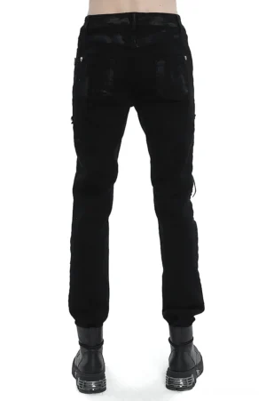 Rear view of black gothic lace-up slim-fit pants showing tapered silhouette, faded paint finish, and structural rear design on male model with combat boots