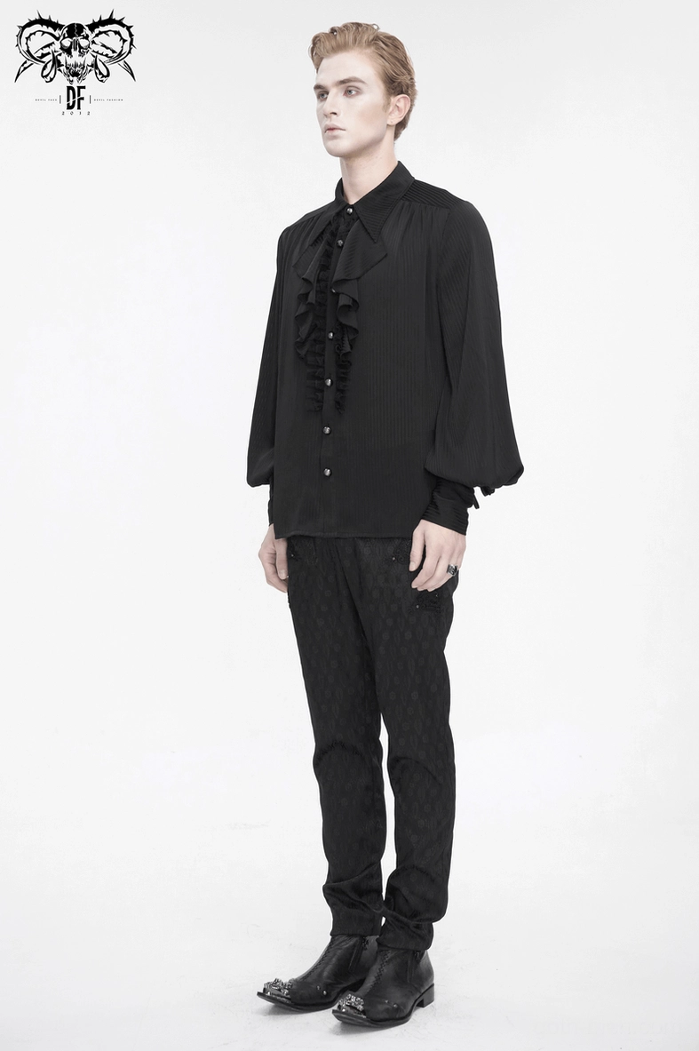Flat lay detail of black gothic ruffled lantern sleeve shirt showing complete front design and gem button placement