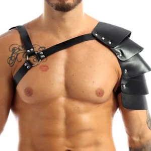 Black faux leather gothic chest harness front view with single shoulder studded armor and metal D-ring hardware on muscular male model