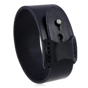 Black gothic wide leather cuff bracelet with antique silver buckle, overhead flat lay view showing stitched edges and metal press studs
