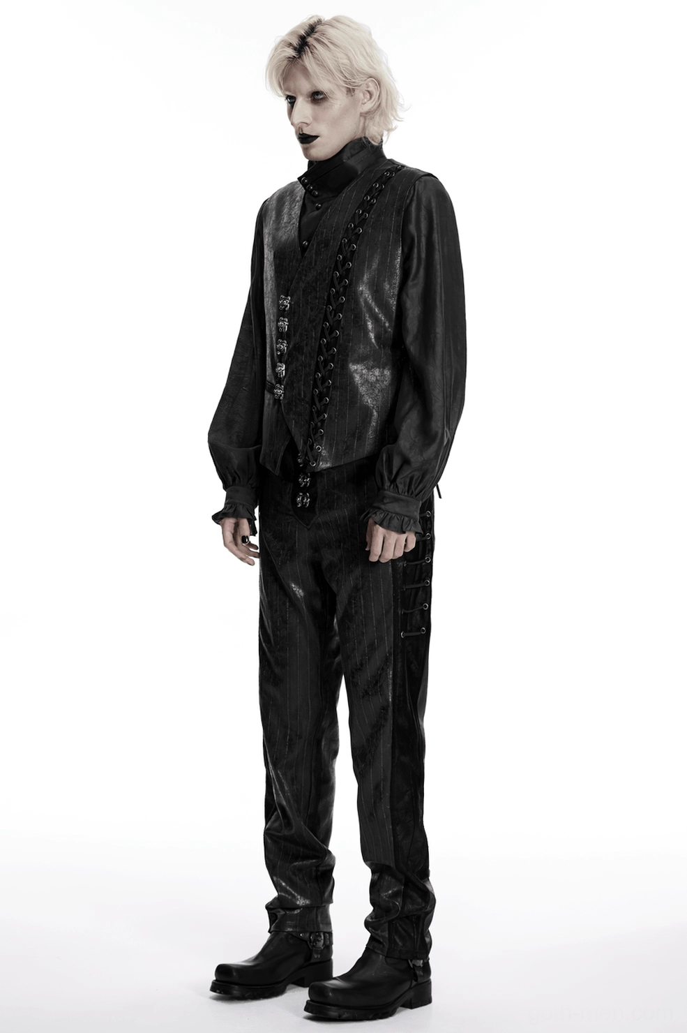 Black gothic leather pants on model displaying fitted cut, pinstripe texture, and metal embellishments