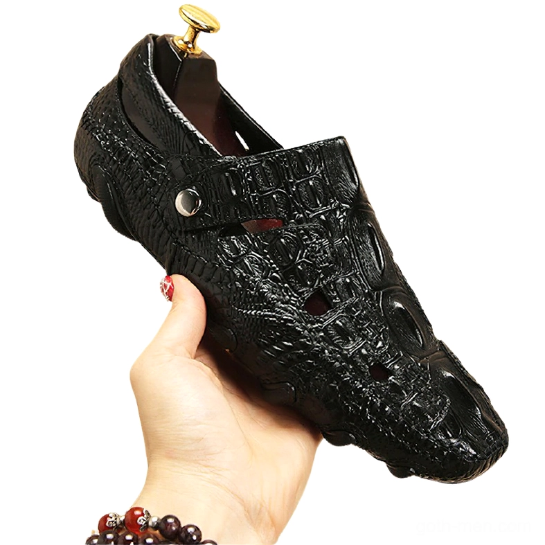 Black gothic loafer held by hand, low angle side view highlighting crocodile leather embossing, metal buckle strap, and premium cow leather construction