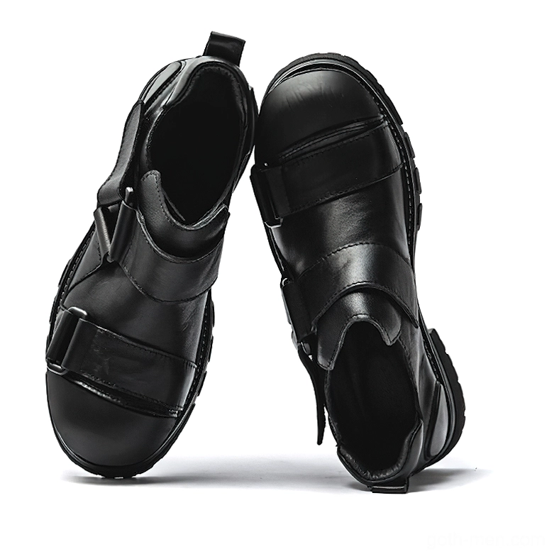 Pair of black leather gothic platform loafers with velcro buckle closures and slip-on design, inner side view