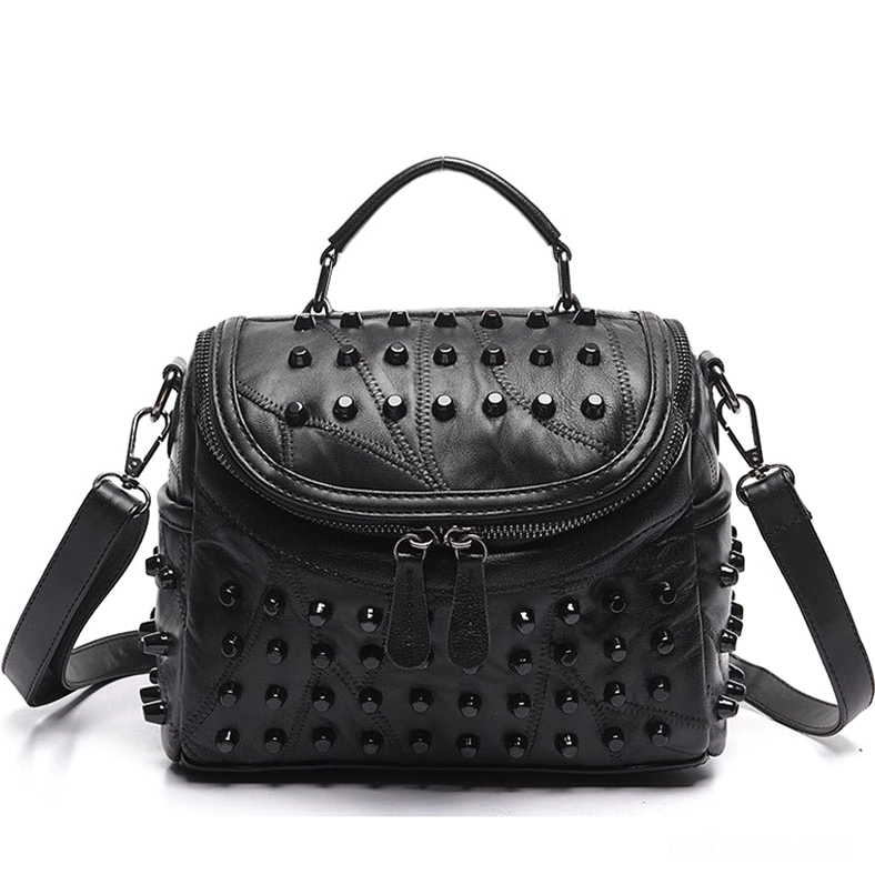 Studded black leather messenger satchel front flat view showing dual zipper pulls and top carry handle