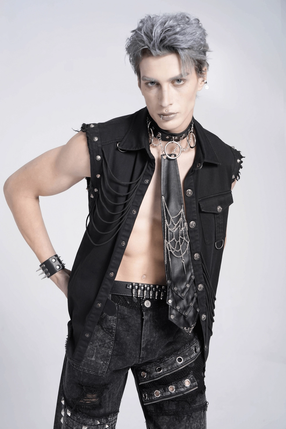 Front view of black gothic necktie with chain decoration on male model showcasing alternative fashion styling