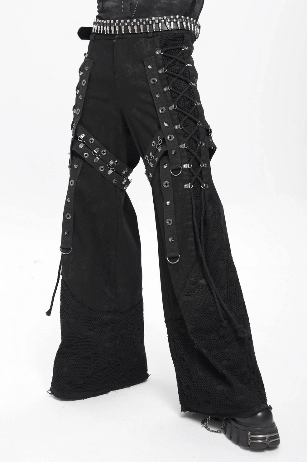 Black gothic punk pants showing button fly closure and distressed mesh panel texture