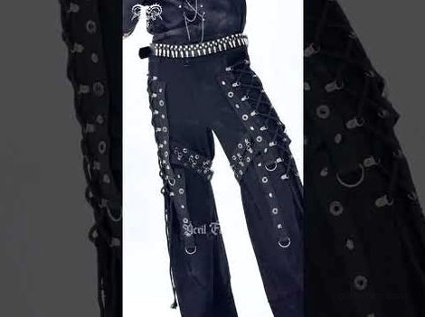 Close-up details of black gothic pants featuring metal ring accents, lace-up grommets, and pyramid studs