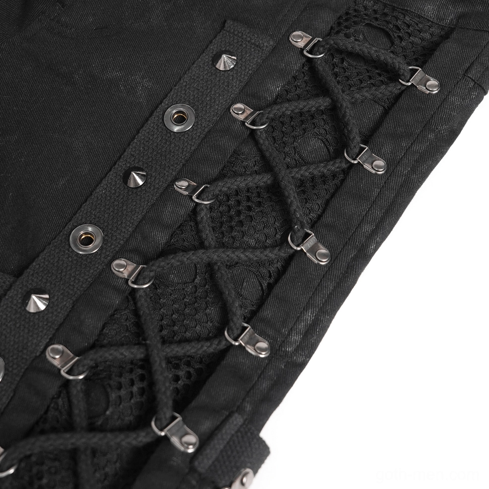 Extreme close-up of metal grommets and lace-up straps on black gothic pants with pyramid studs