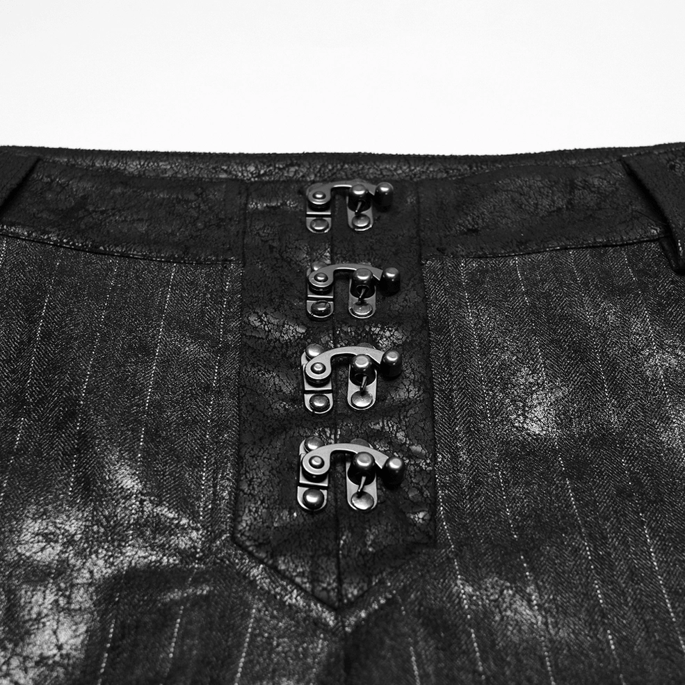 Close-up detail of metal claw clasp fasteners and pinstripe woven fabric on black gothic pants waist