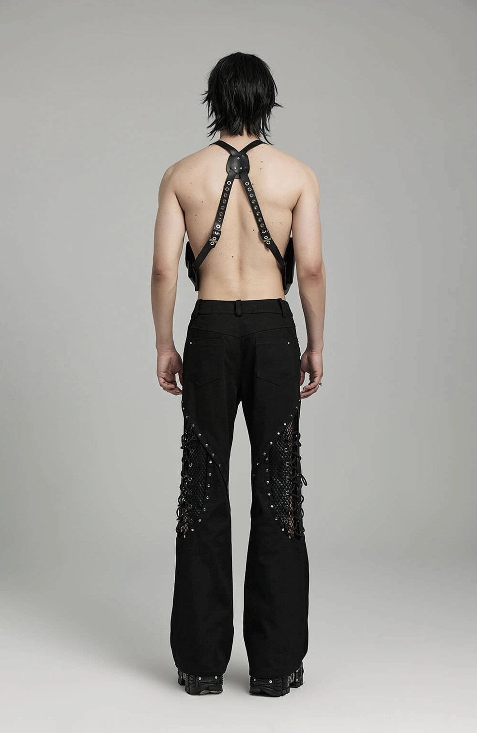 Metal rivet studded segmented lace-up lines on black gothic alternative pants