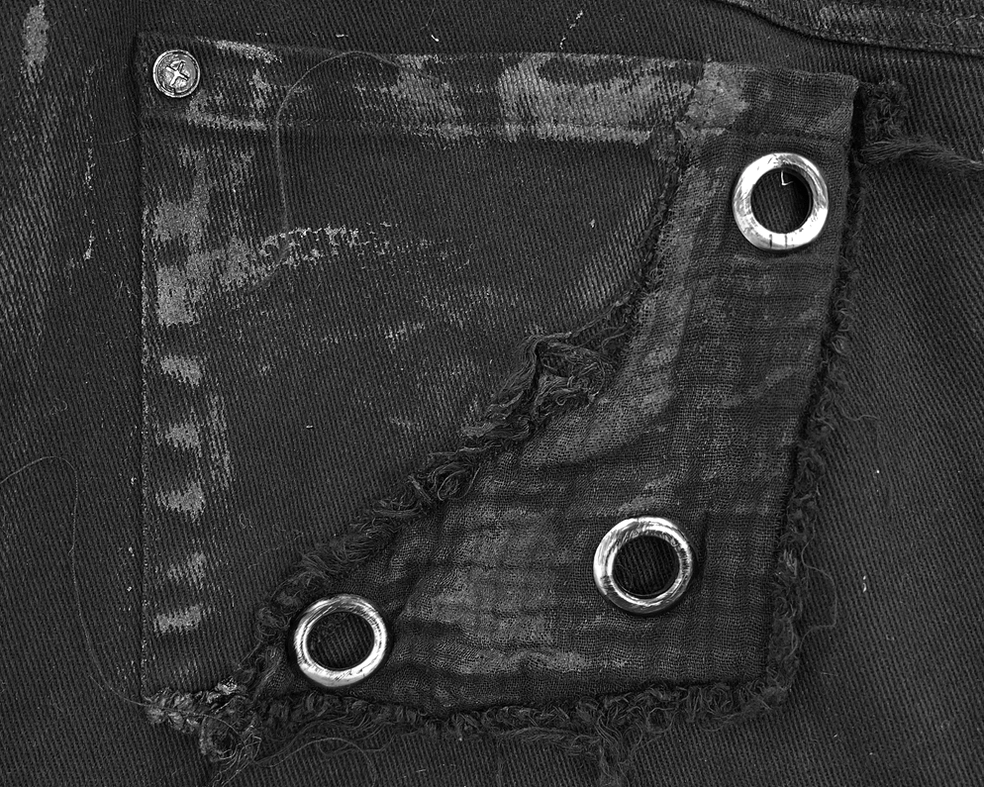 Black punk rock cargo pants highlighting stud placement and distressed textile craftsmanship