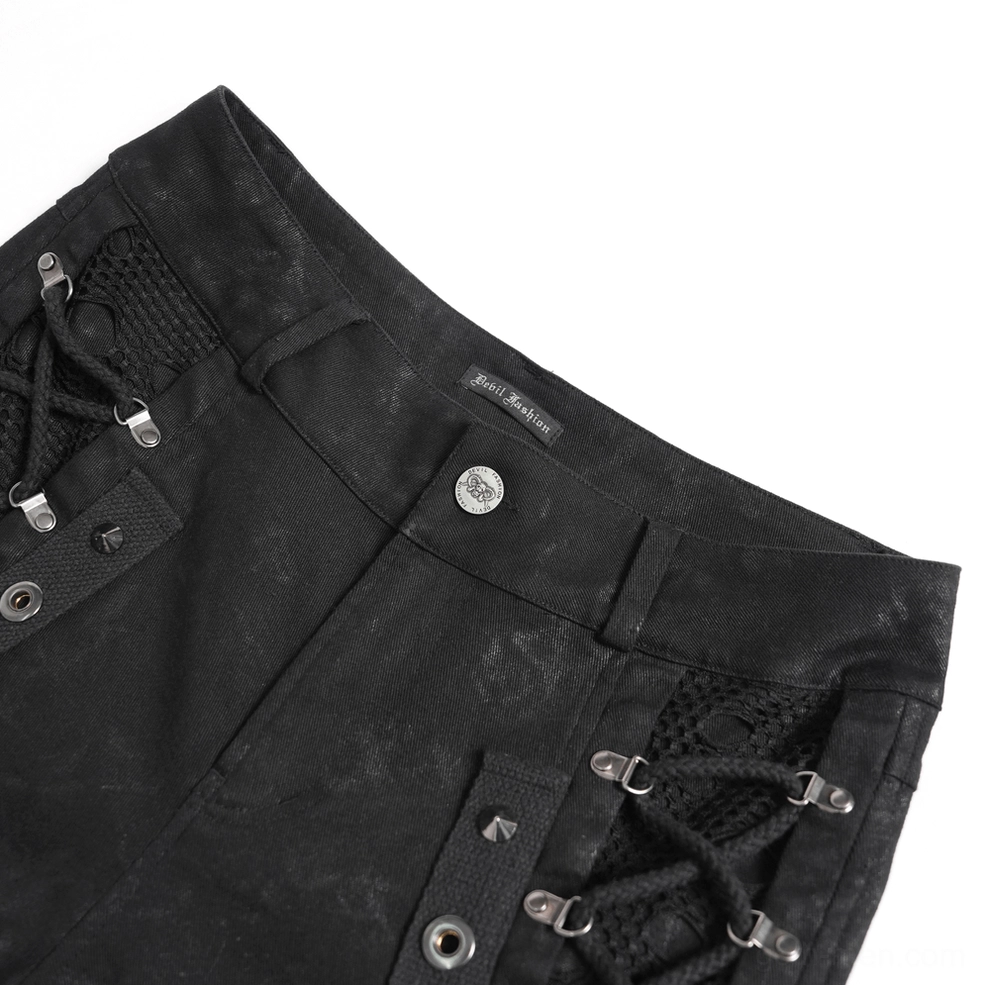 Close-up of black gothic pants waist detail showing distressed fabric, metal rivets, and lace-up mesh panel