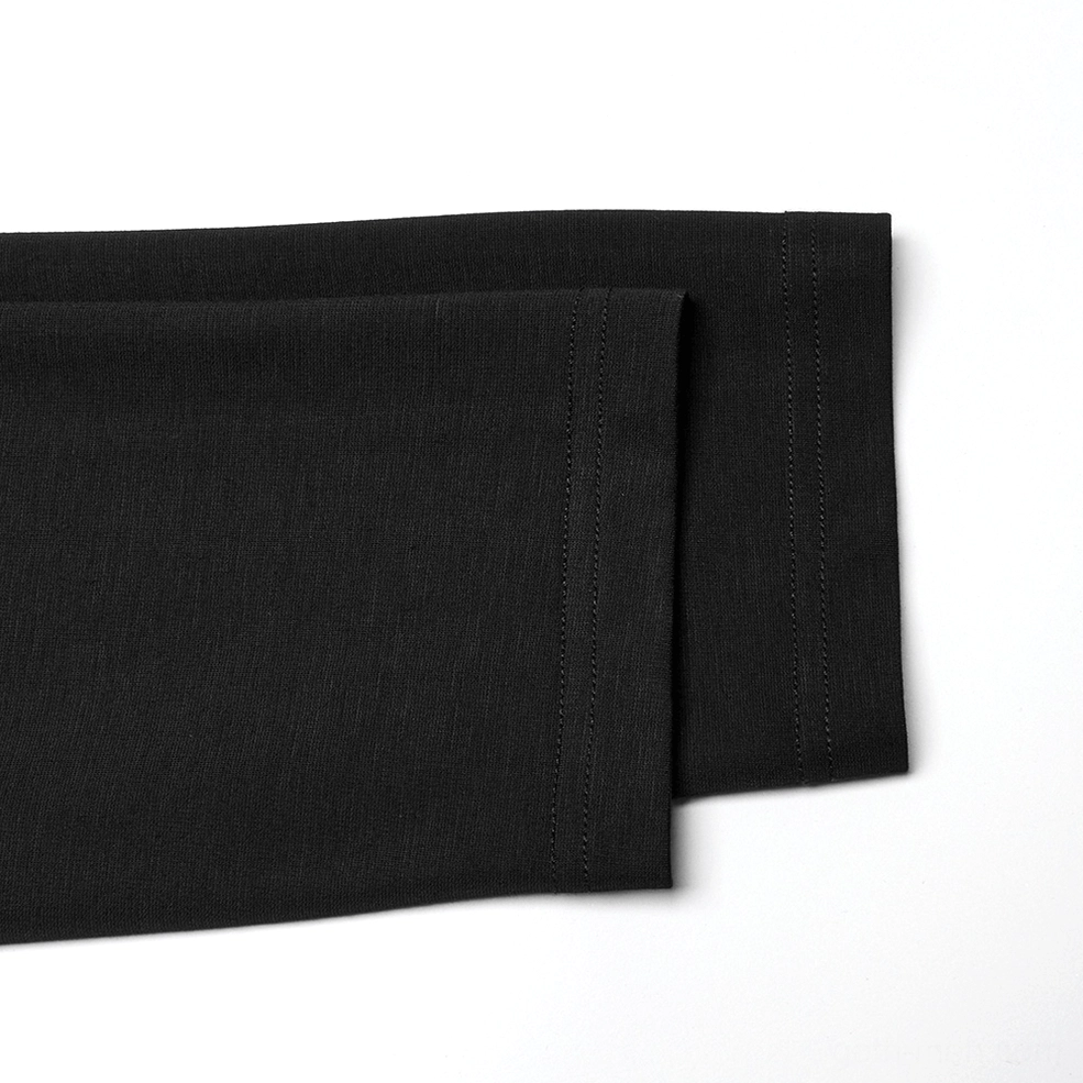 Black gothic top fabric texture and sleeve seam detail showing quality construction