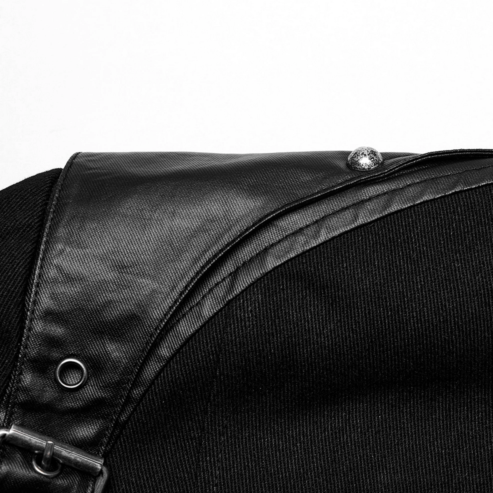 Black gothic punk jacket shoulder section close-up, displaying metal snap button, leather panel, and eyelet construction