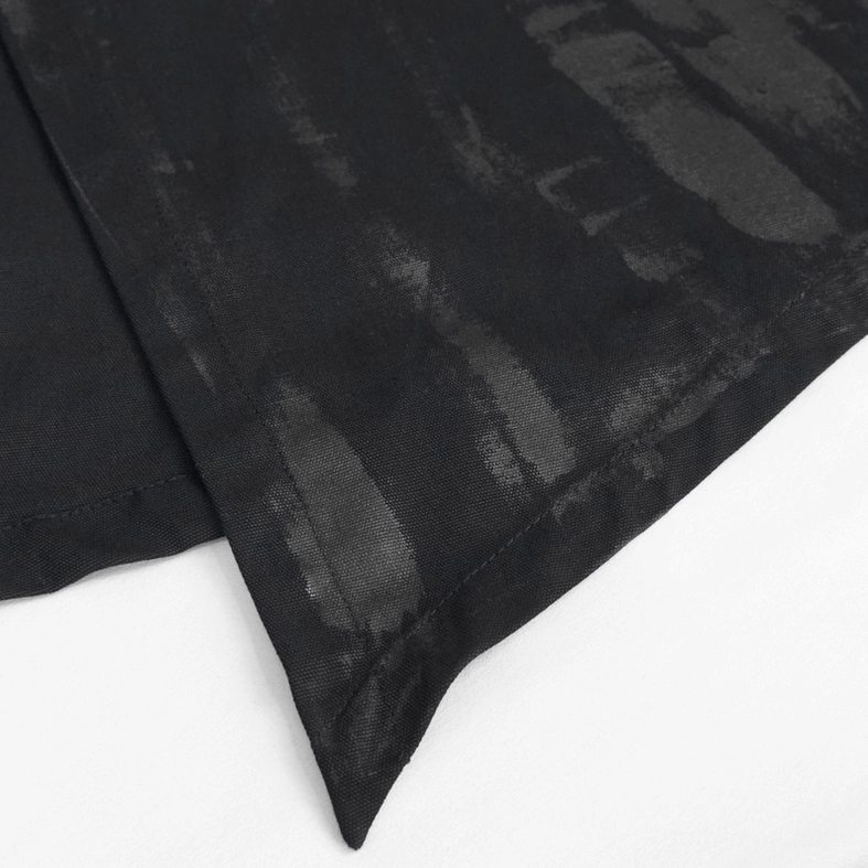 Textured close-up of black gothic punk kilt leather material showing PU leather finish and rivet hardware