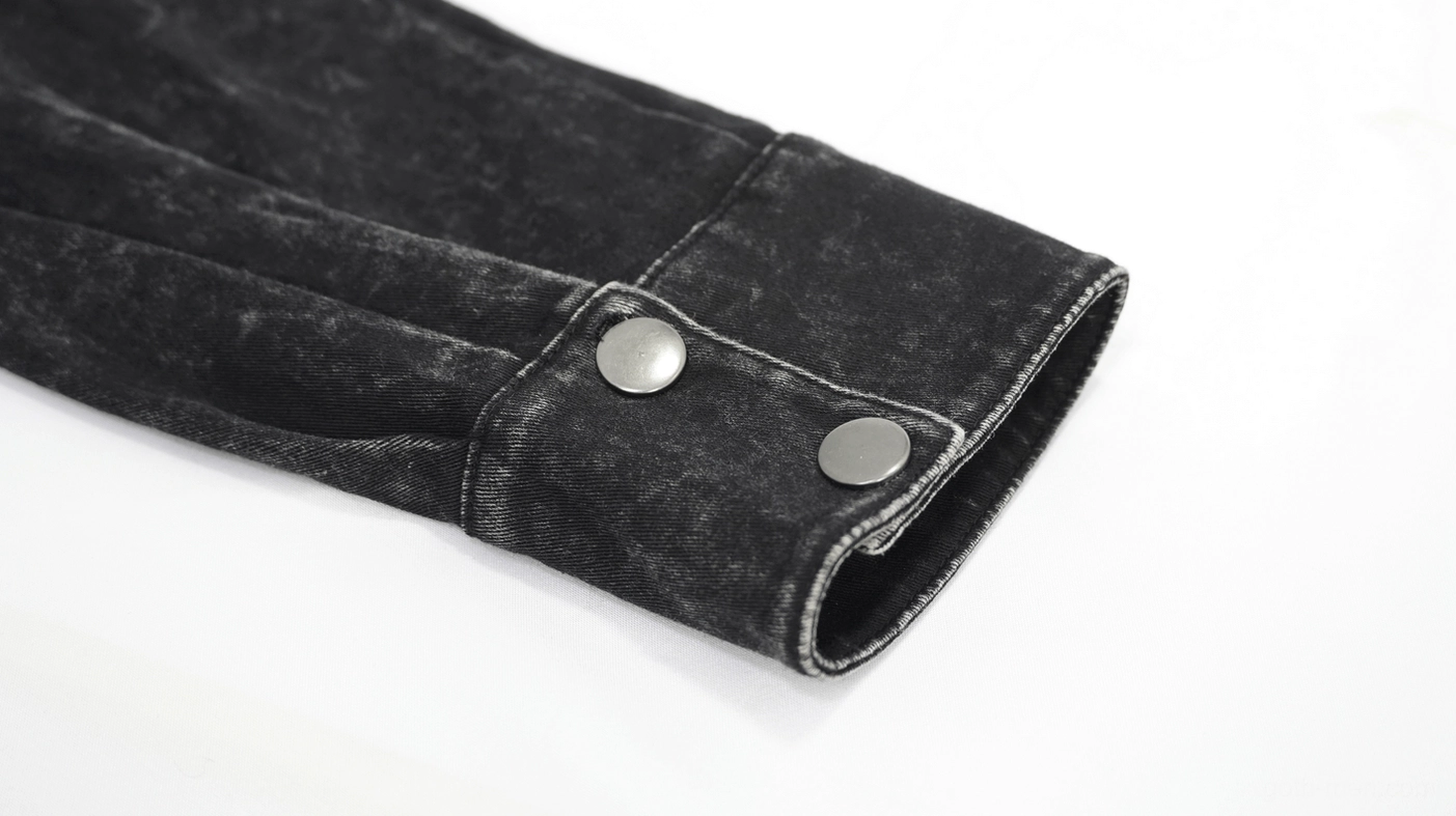 Close-up product detail of black gothic punk shirt showing texture of torn mesh, leather components and metal hardware finish